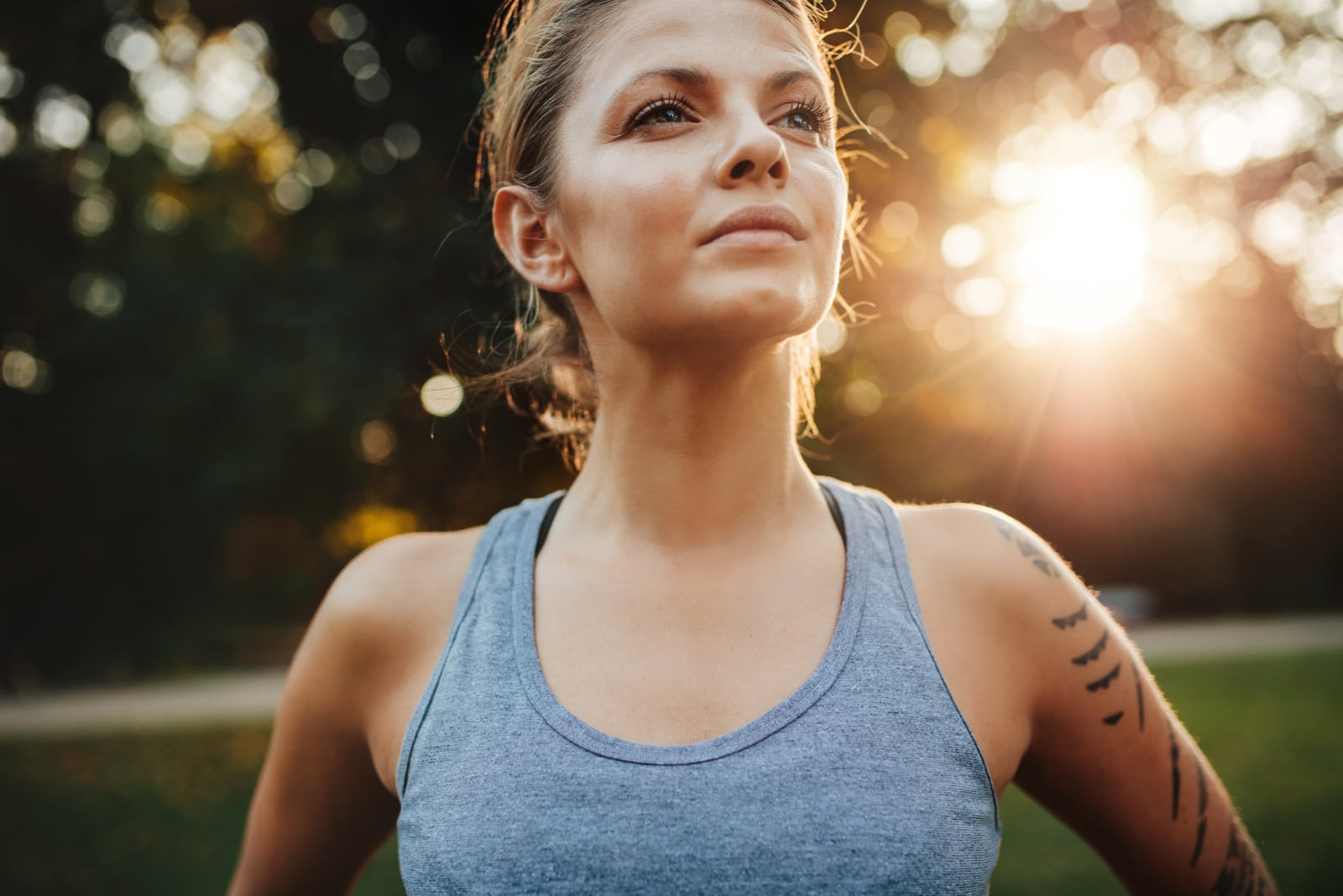 young woman in sportswear standing outdoors