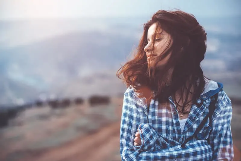 young woman standing on the mountain
