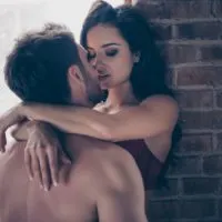 a man and a woman kiss