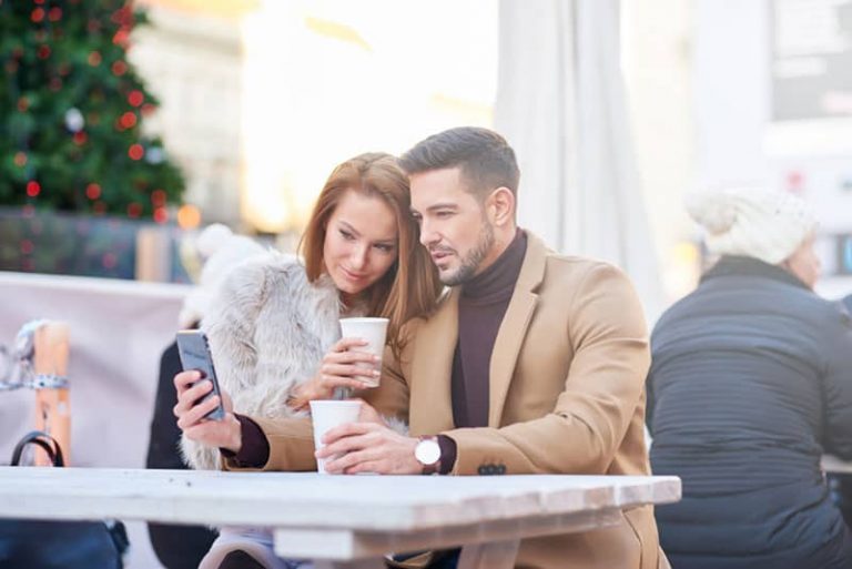 couple in city looking smartphone
