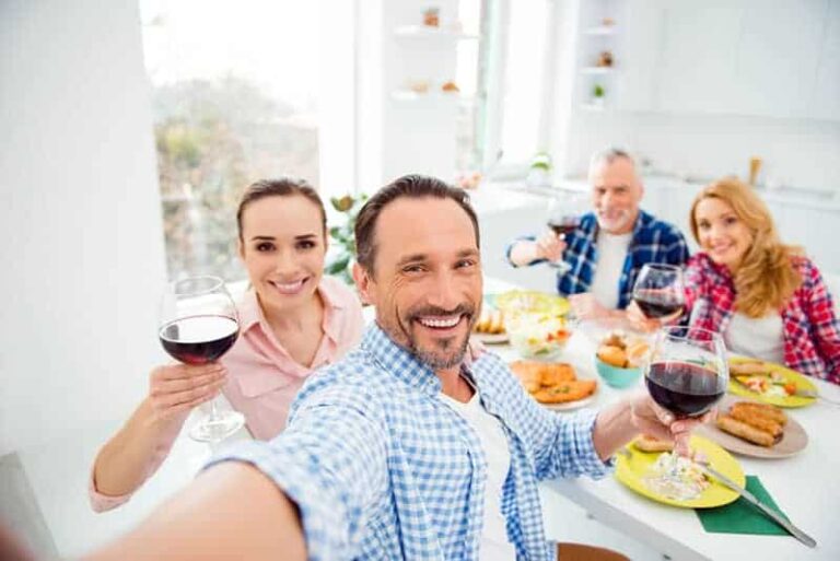 man taking selfie while having family dinner