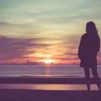 lonely woman watching sunset