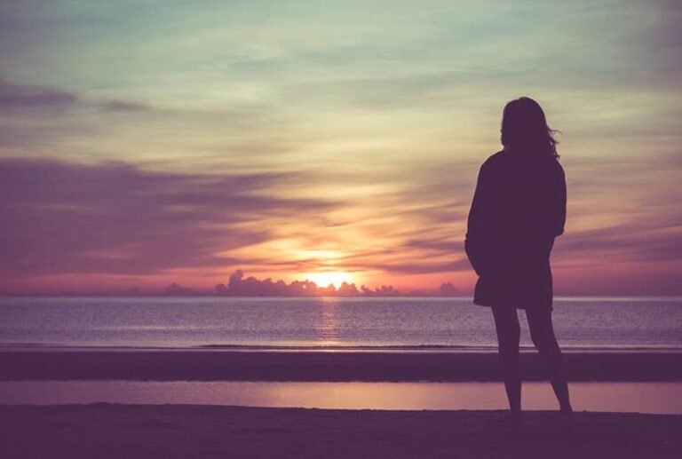 lonely woman watching sunset