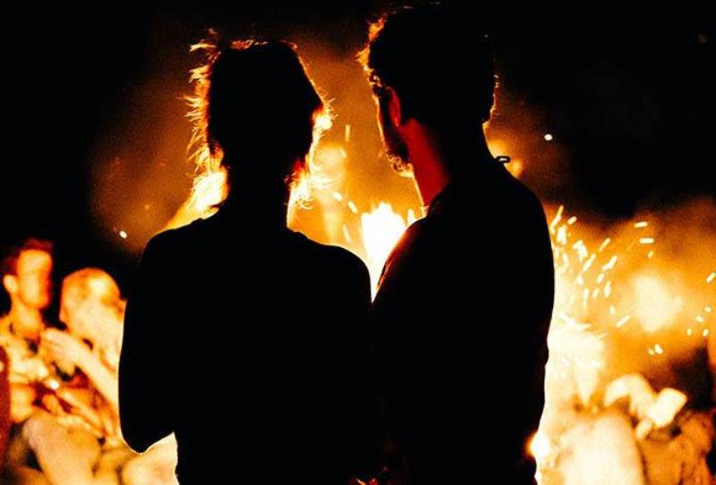 couple standing in front of flame