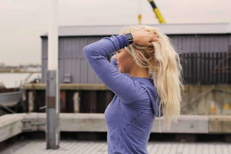 Woman holds hair outside