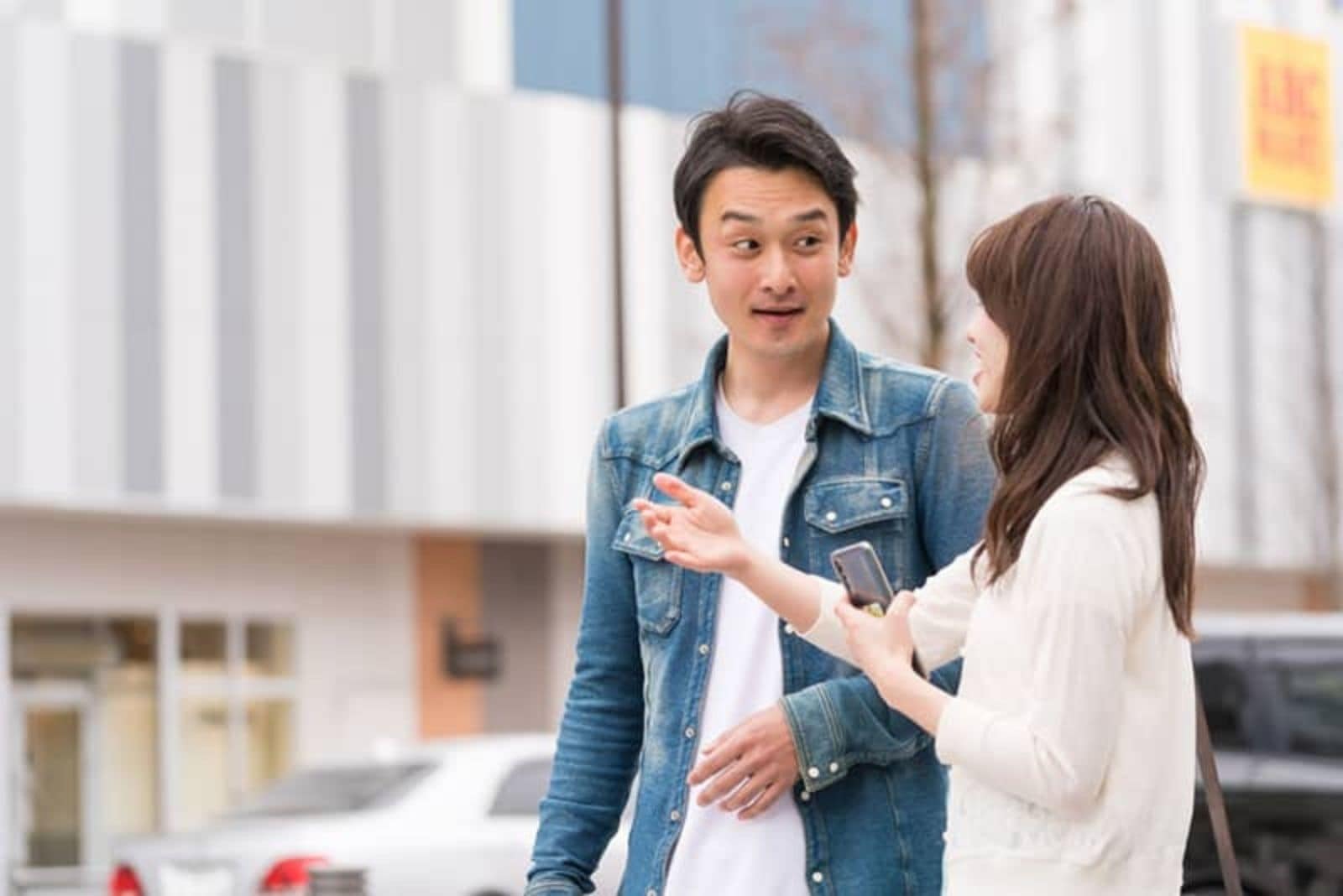 a woman talking on the street with a man