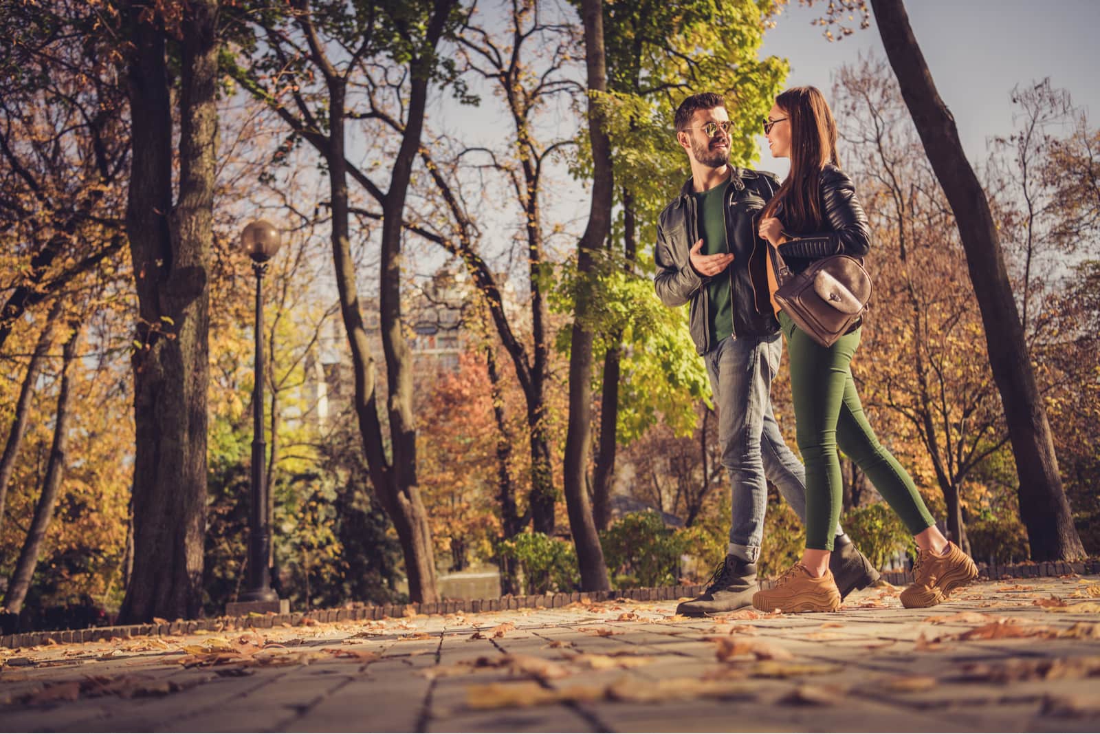 una coppia di innamorati attraenti passeggia nel parco e parla