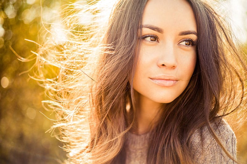 attractive woman standing in sunlight