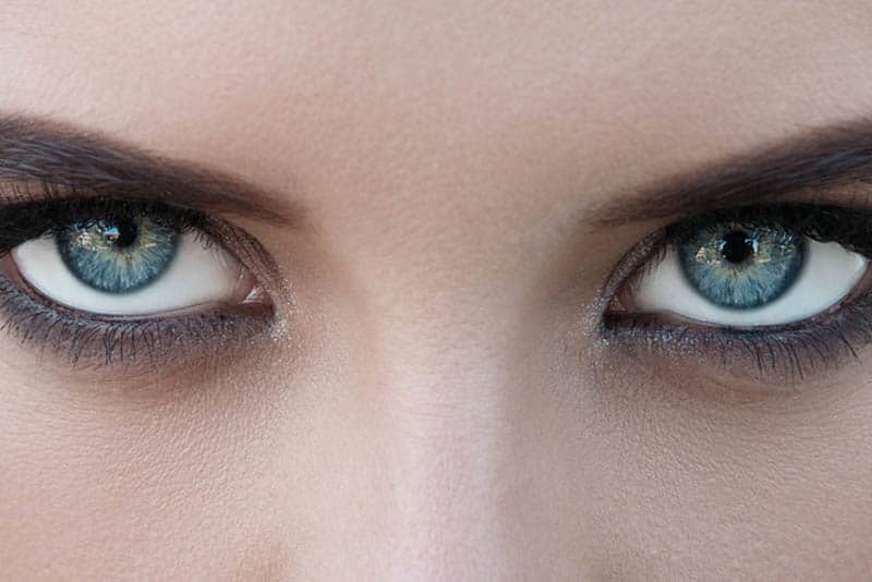 close up photo of female with blue eyes