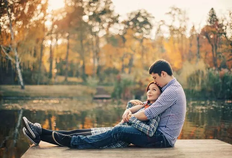 couple sitting on wooden dock