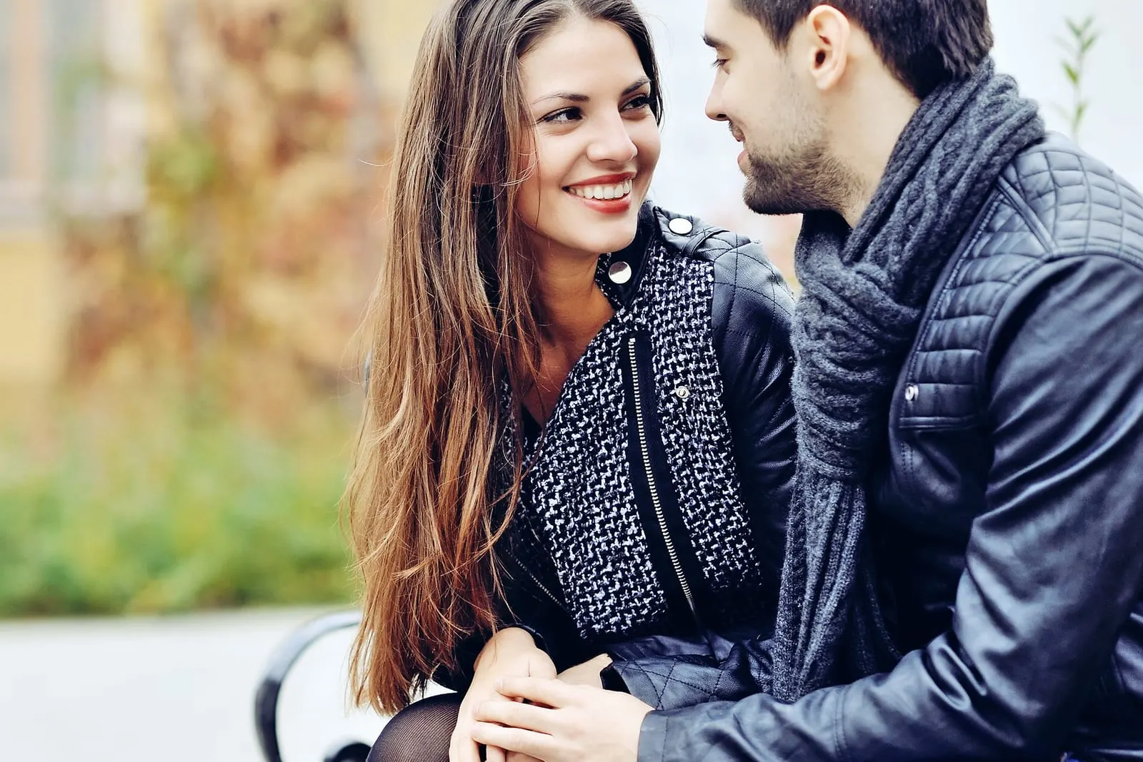  couple smiling and looking each other outdoors