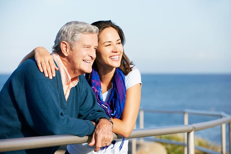 father and daughter looking at sea