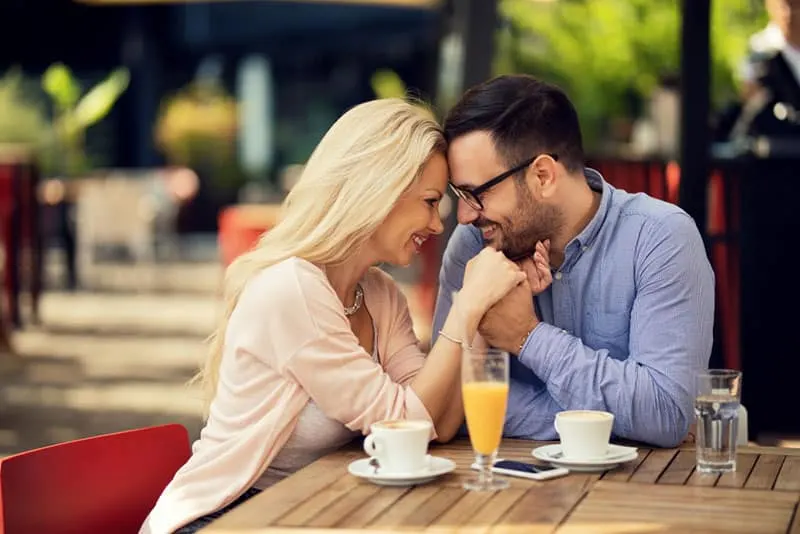 lovely couple facing each other at cafe