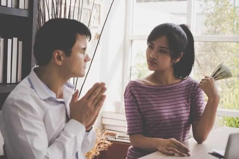 man asking woman for money