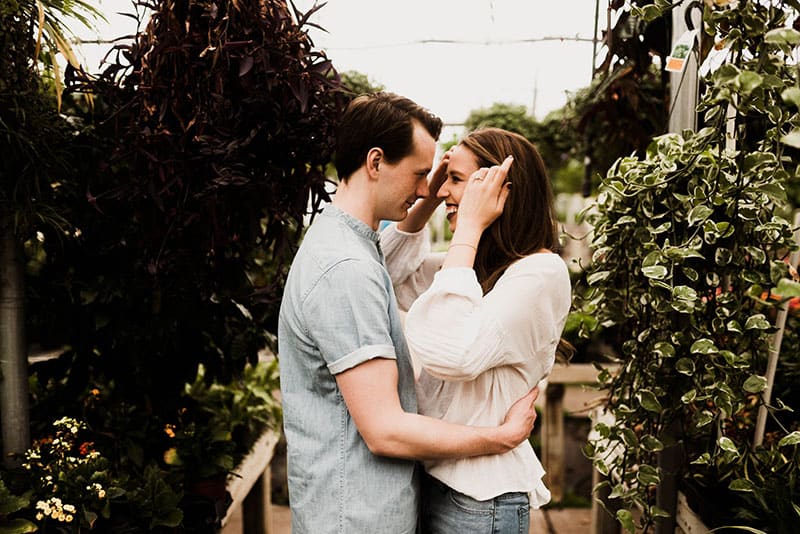 man hugging smiling woman outside