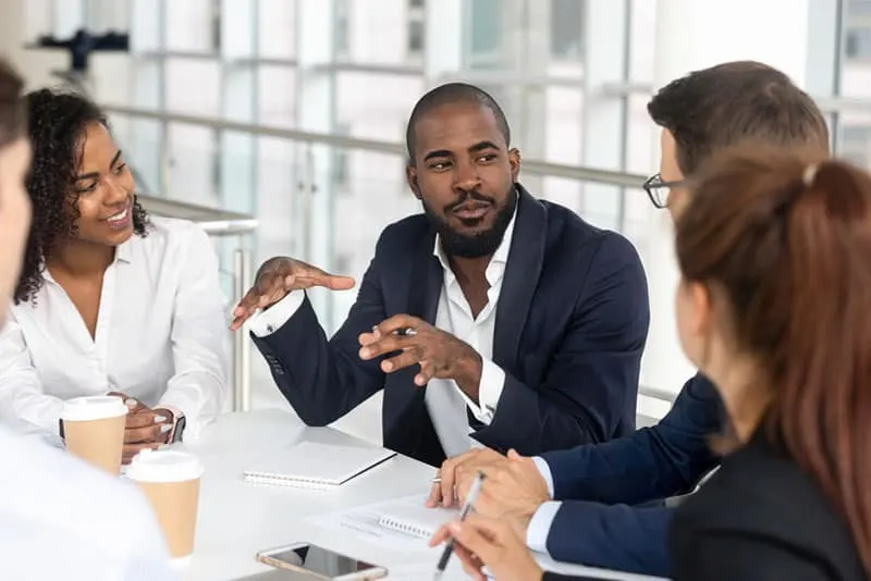 man talking to his work colleagues