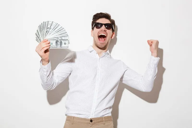 man with sunglasses showing money