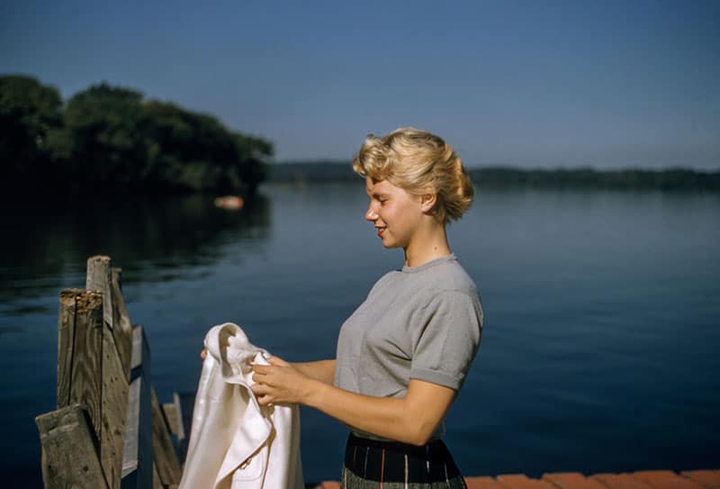 old fashioned woman holding a shirt