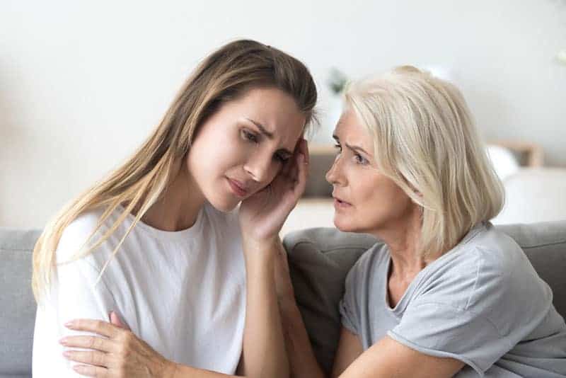 sad daughter sitting with her mother