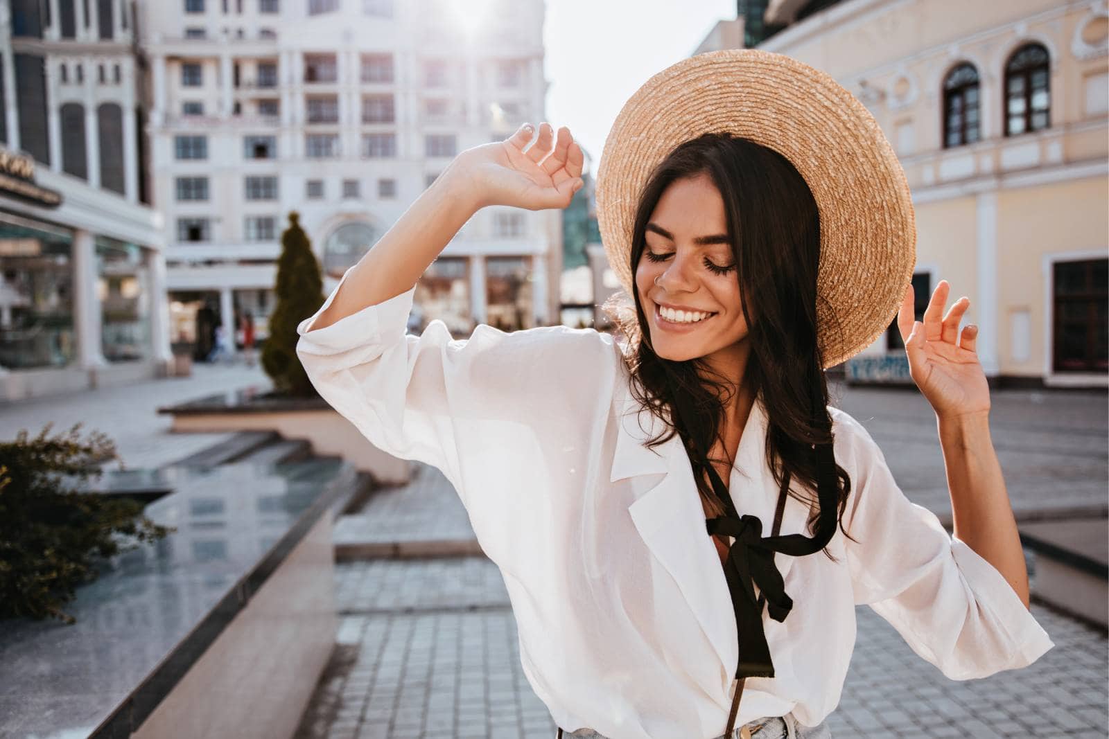 smiling woman outside wearing hat