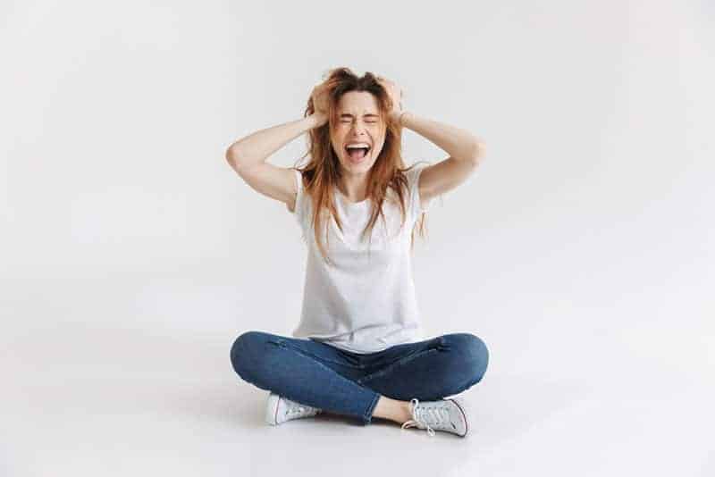 stressed woman holding for her head