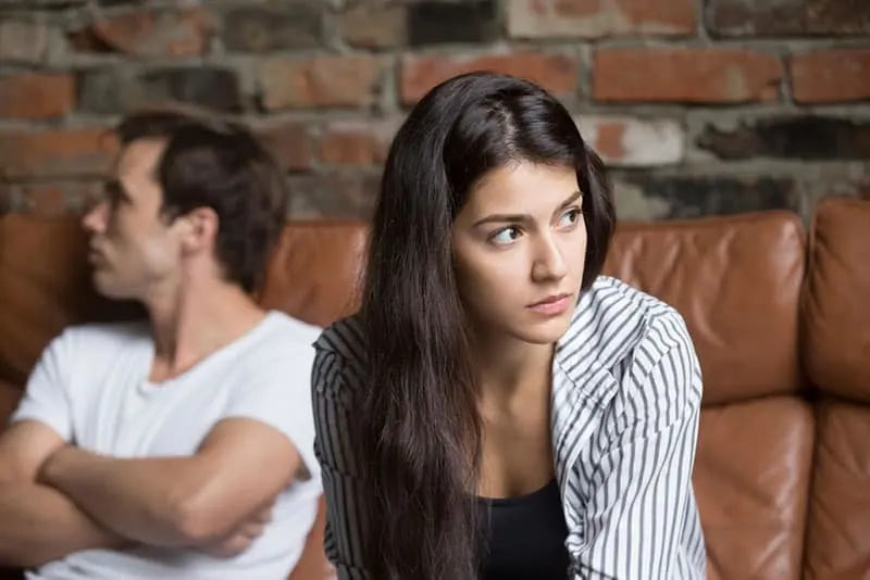 thoughtful woman sitting with her man at home