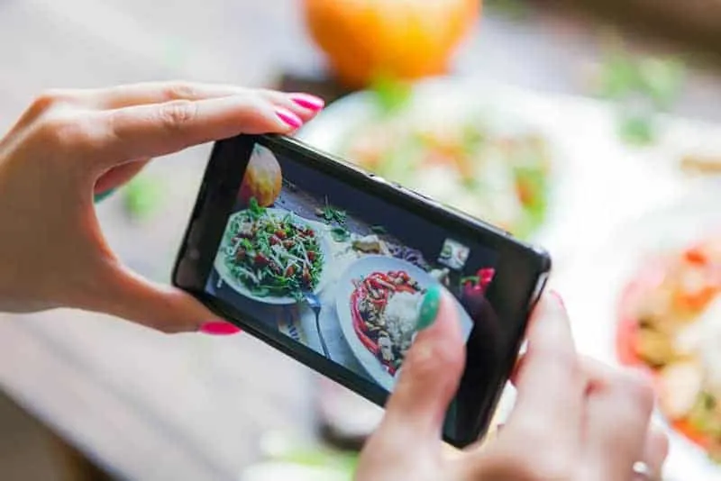 woman taking picture of food for instagram