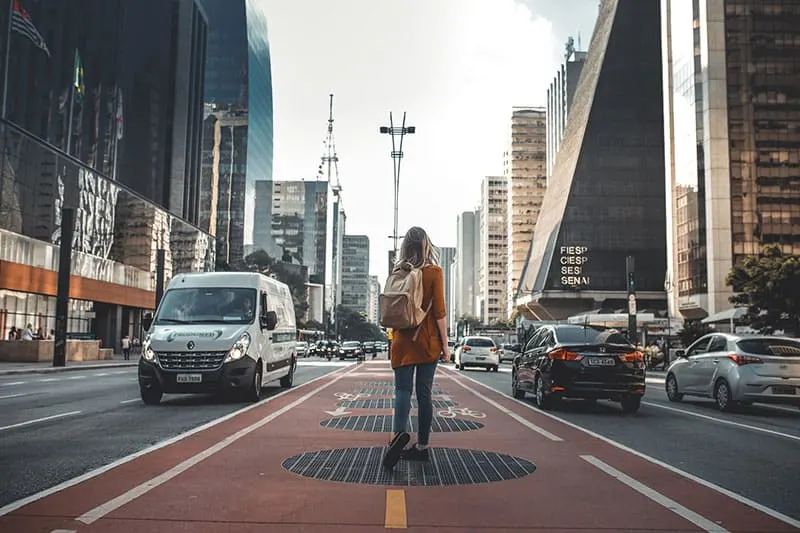 woman walking through big city