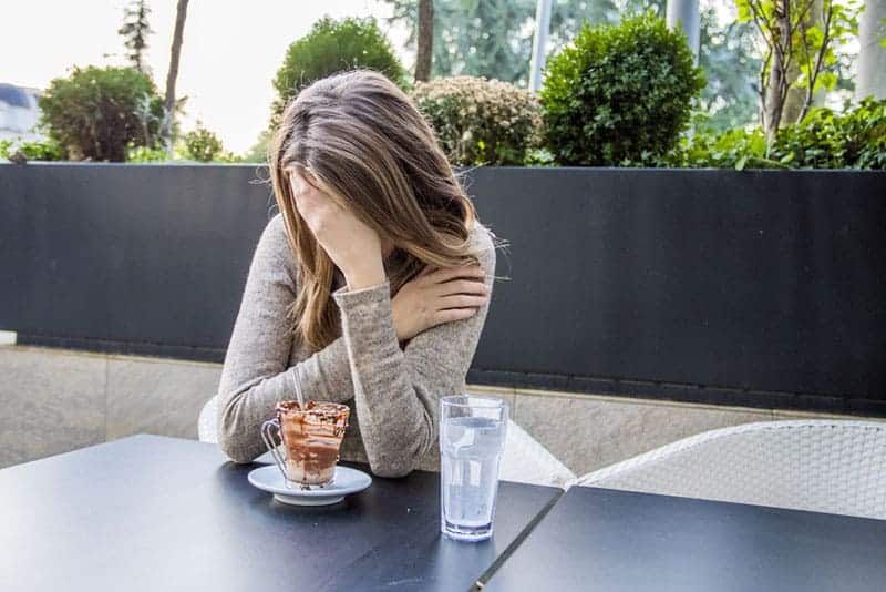 worried woman holding hand on her head