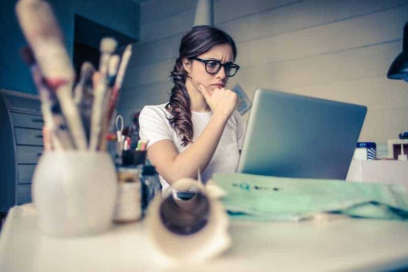 worried woman looking at computer