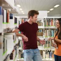 man and woman talking at library