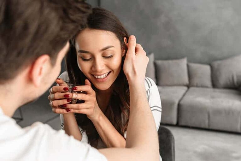 girl smiling while her man touching her hair