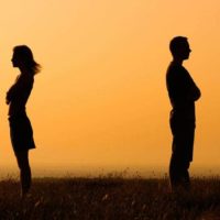 silhouette of couple standing against each other