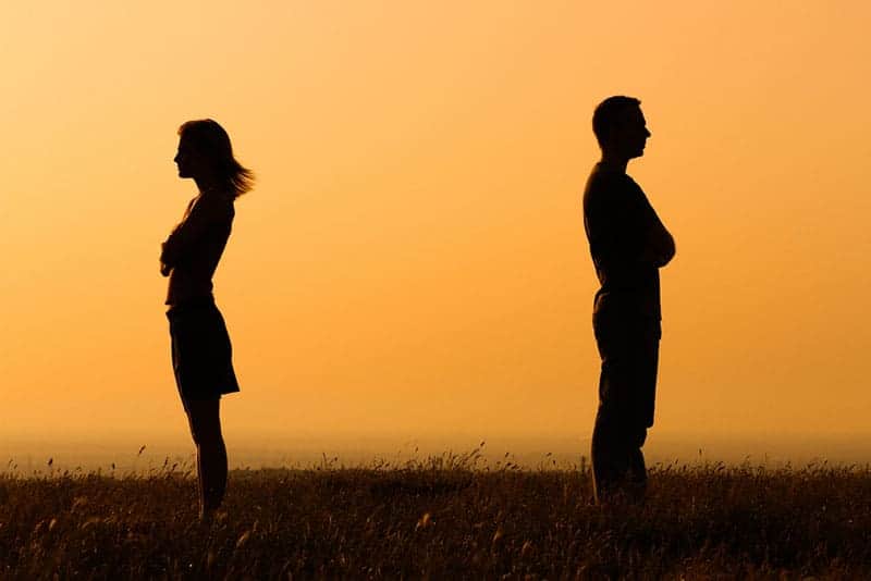 silhouette of couple standing against each other
