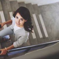woman walking on stairs and looking up