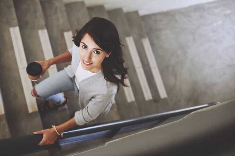 woman walking on stairs and looking up