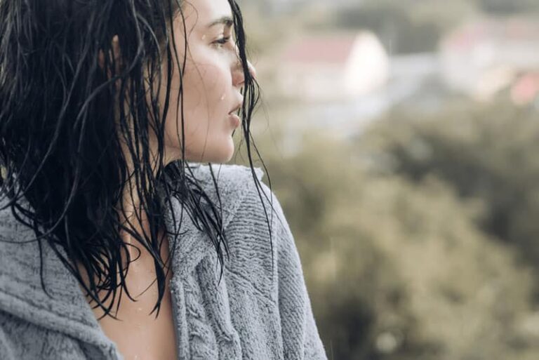 sad woman standing on the rain