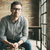 portrait of man wearing eyeglasses and sitting