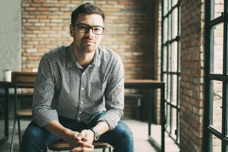 portrait of man wearing eyeglasses and sitting