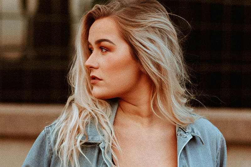 young blonde woman looking over shoulder