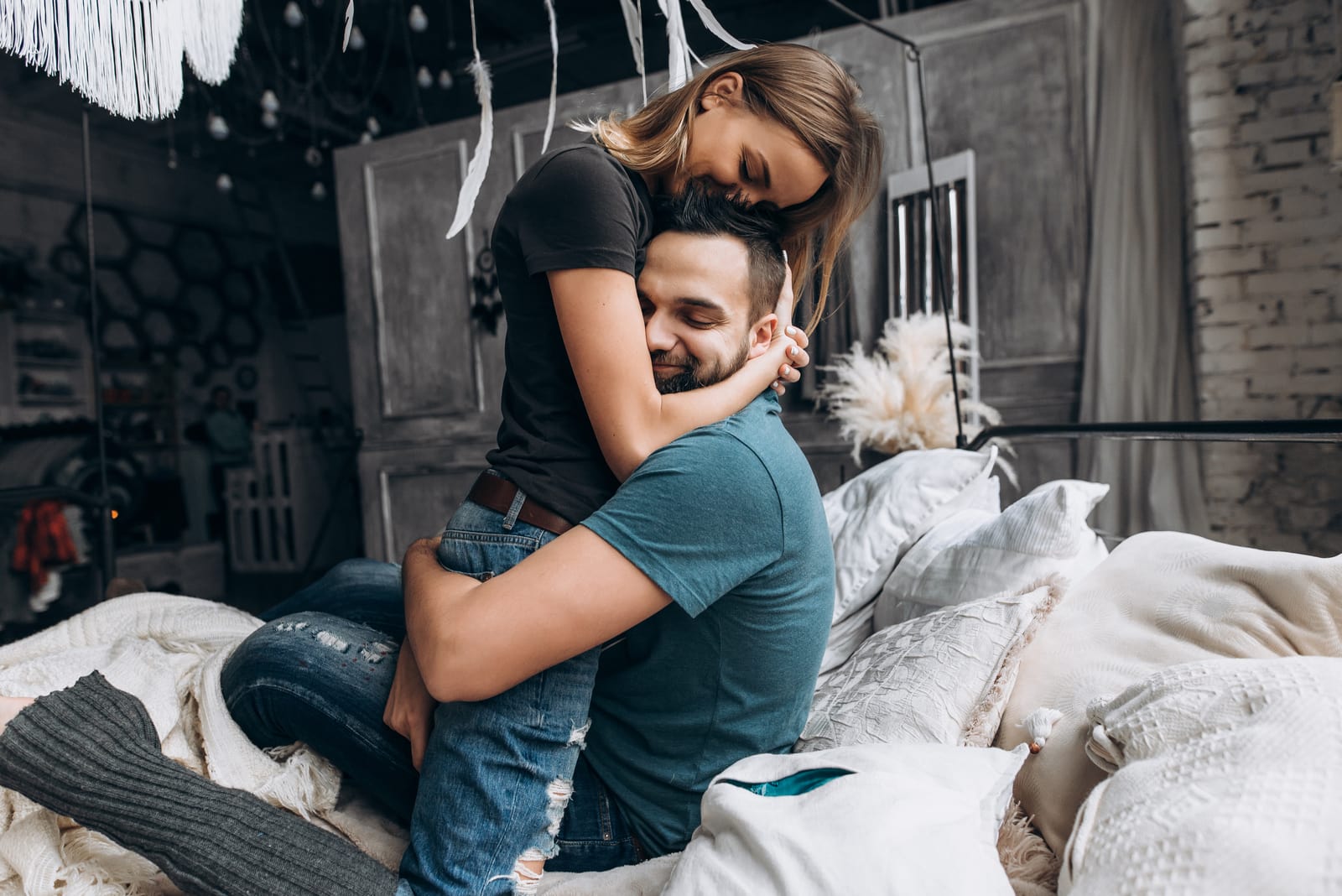 a couple in love hugging on the bed