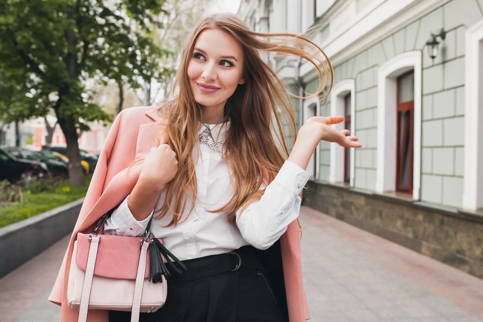 a young beautiful brunette walks through the city