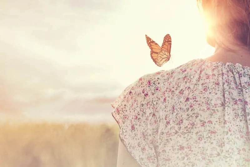 butterfly on woman shoulder