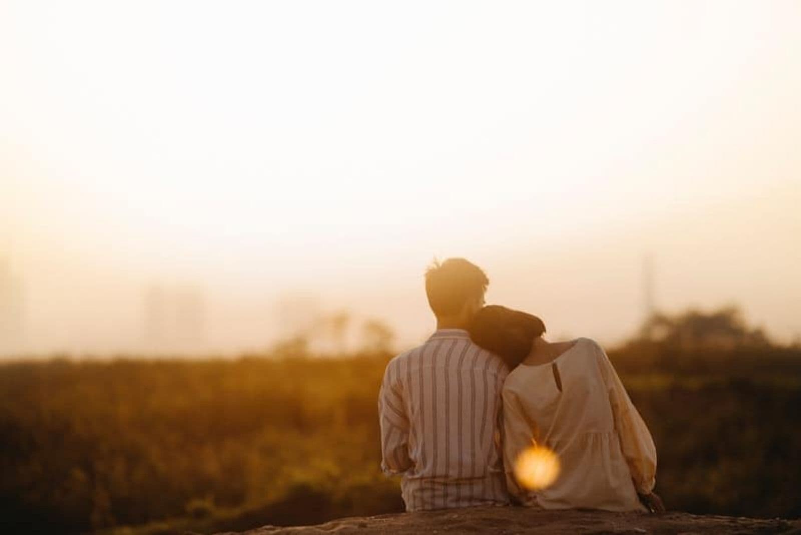 couple embraced in nature watching sunset