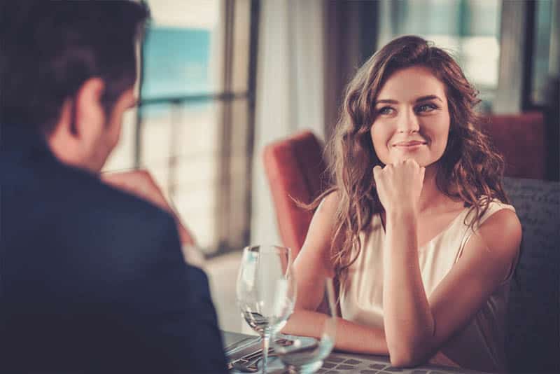 cute woman looking at man at restaurant