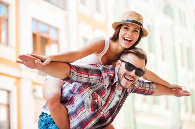 happy man piggybacking woman