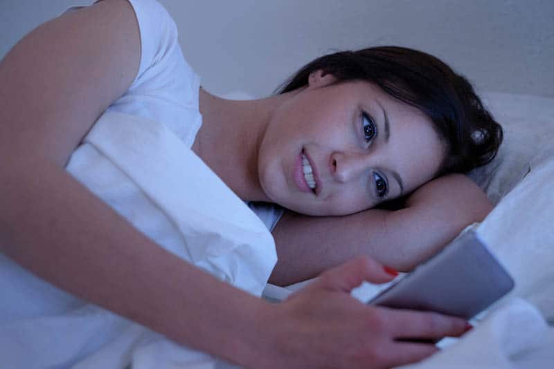 happy woman looking at phone