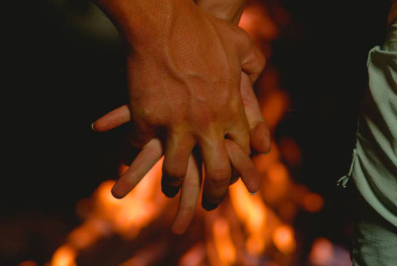 man and woman interlocking fingers