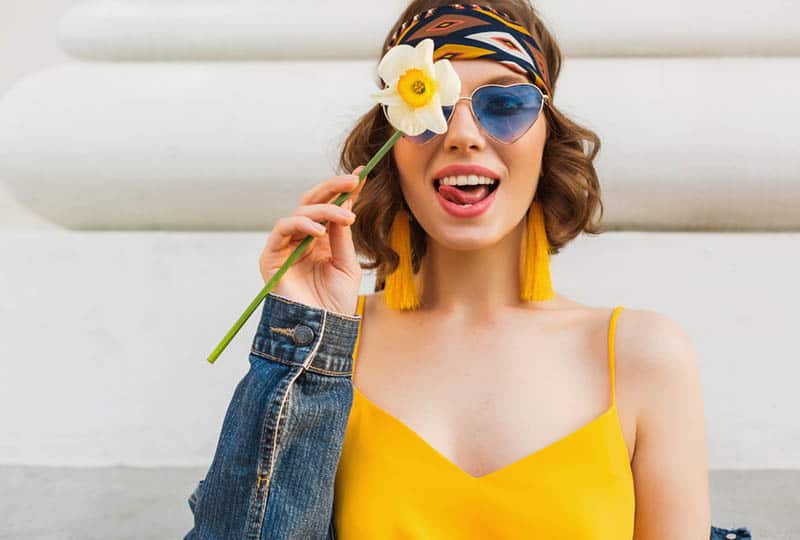 nice girl holding a flower on her face