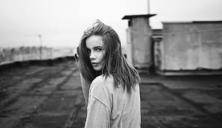 black white photo woman on a roof